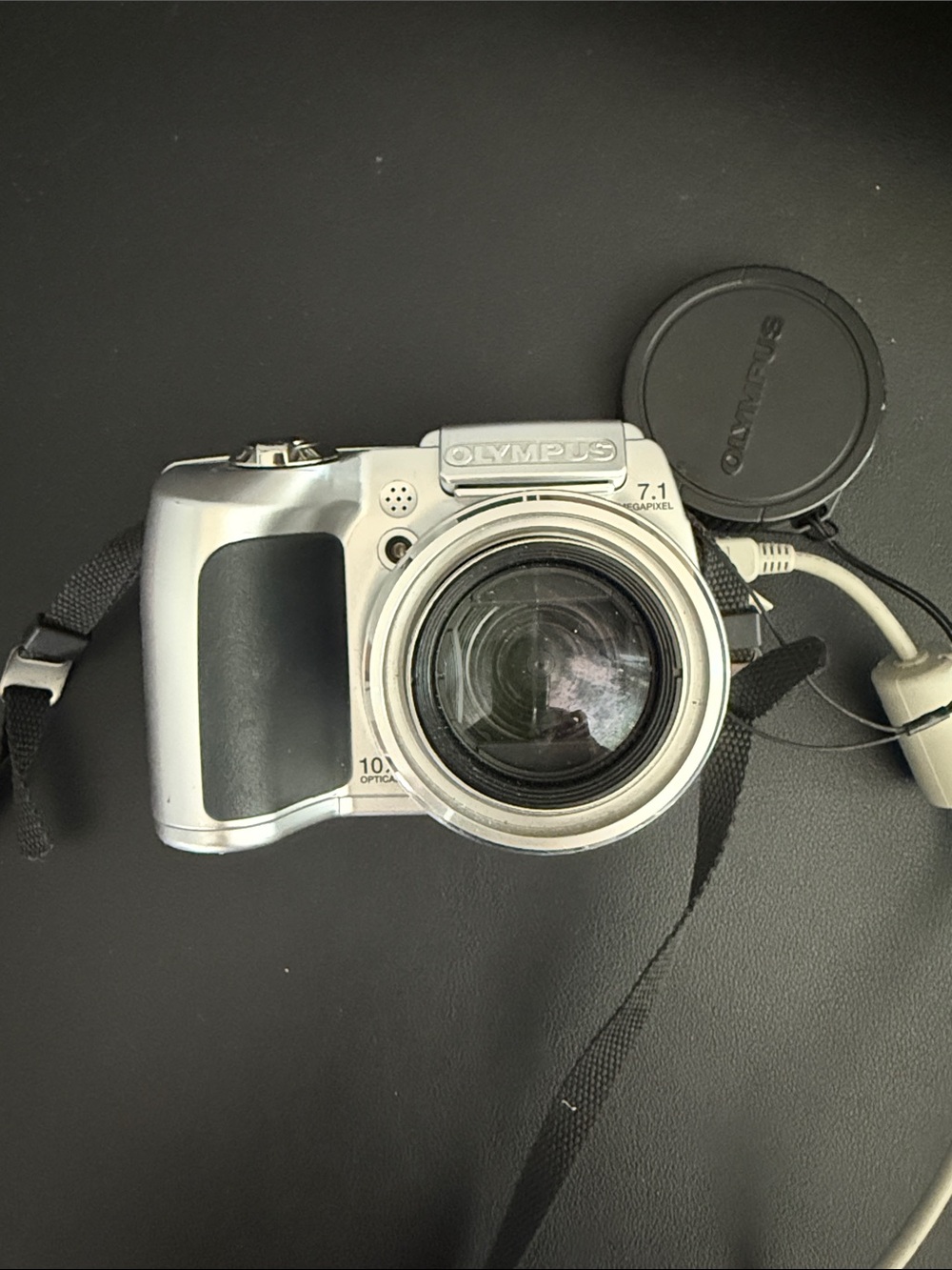 Olympus Silver Digital Camera with Black Grip and Strap
